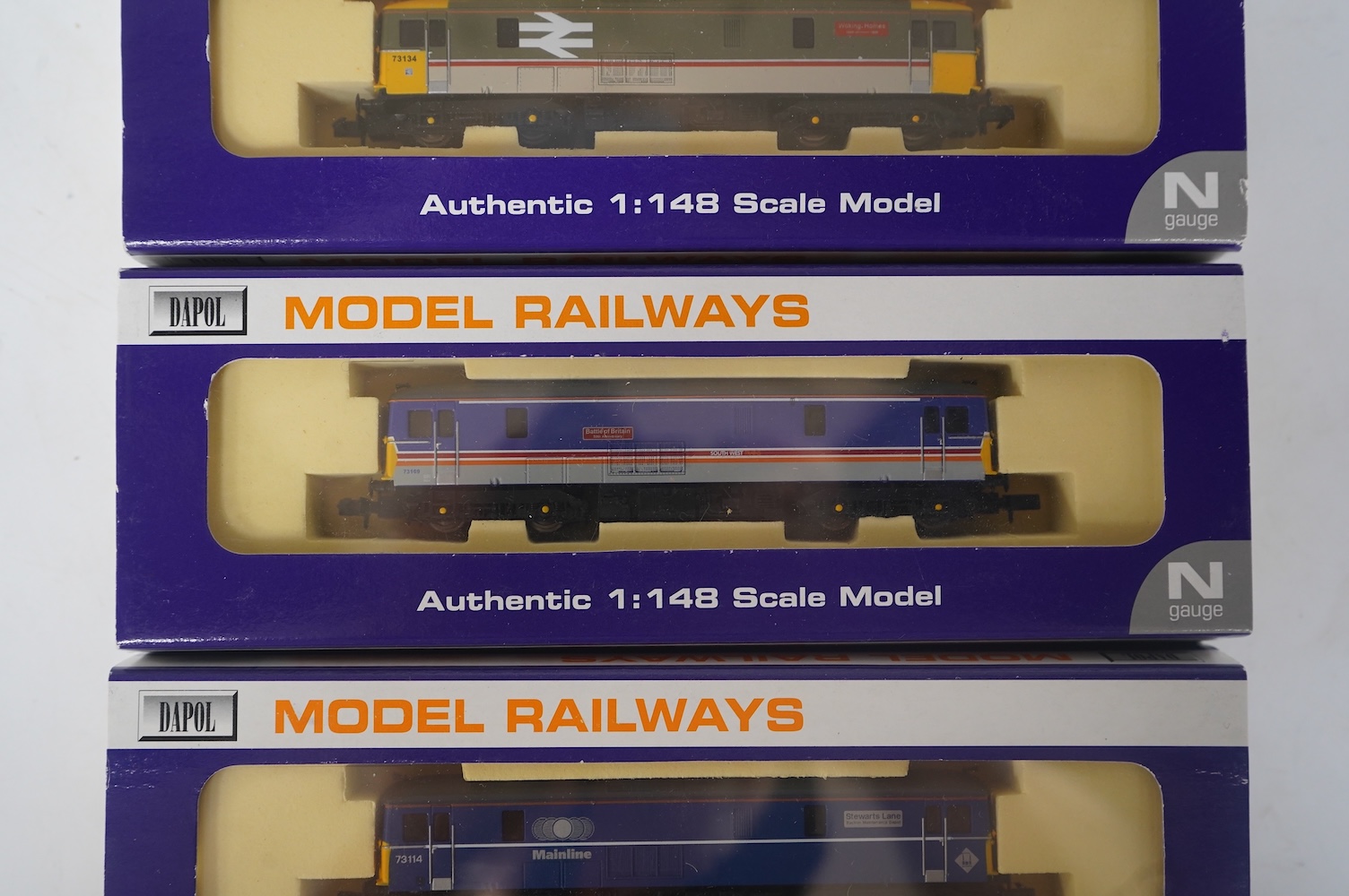 Three boxed Dapol N gauge railway Class 73 electro-diesel locomotives; 73109 Battle of Britain (ND006), 73114 Stewarts Lane (ND-021a) and 73134 Woking Homes (ND-007). Condition - good.